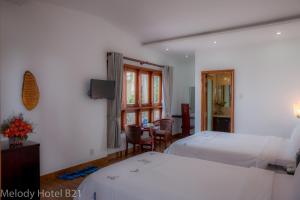 Postel nebo postele na pokoji v ubytování Melody Hotel
