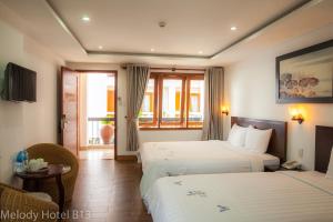Postel nebo postele na pokoji v ubytování Melody Hotel