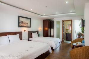Postel nebo postele na pokoji v ubytování Melody Hotel