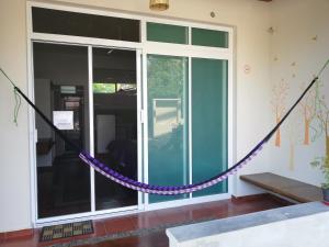 a purple rope tied to a room with a window at Casa Puerto Bonito & Private Coworking in Puerto Escondido
