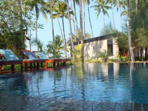 a resort with a swimming pool with palm trees at Pleasant View Resort in Ngapali