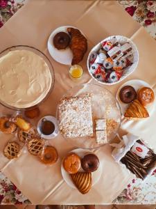 a table topped with lots of different types of pastries at Chalet negli ulivi in Silvi Paese