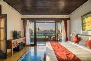 a bedroom with a bed and a window with a view at Villa Tanah Carik by Mahaputra in Tegalalang