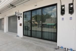 a store front with large glass windows and a door at Loft Series by Pak-Up in Krabi town