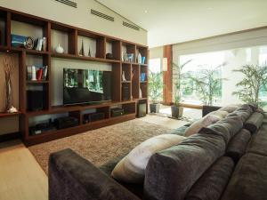 a living room with a couch and a television at Under the Stars Luxury Apartment in Boracay