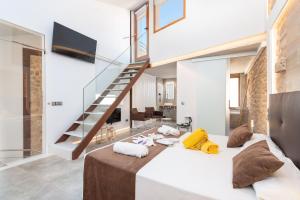 a bedroom with a large bed and a staircase at Hotel Can Simo in Alcudia +9 photos