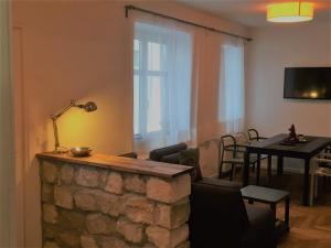 a living room with a table and a stone fireplace at Appartement UH55 in Neusiedl am See