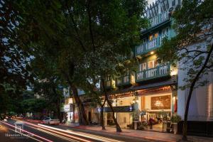 eine Stadtstraße in der Nacht mit einem Gebäude in der Unterkunft Hanoian Central Hotel & Spa in Hanoi