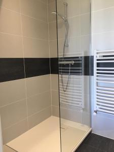 a shower with a glass door in a bathroom at FalHappy House in Poisy