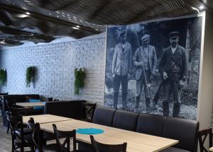 a mural of three men on a wall in a restaurant at B&B Mierontie Oy in Konnevesi