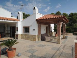 a patio with a gazebo in front of a house at Finca Mirador in Macastre +32 photos