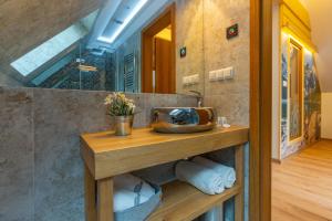 a bathroom with a sink and a mirror at Stacja Zakopane - Apartamenty w centrum in Zakopane