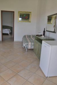 a living room with a refrigerator and a couch at Agriturismo Rubinu in Galtellì