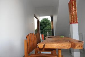 a dining room with a wooden table and two chairs at Karma Amed Guesthouse in Amed +38 photos