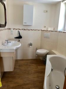a bathroom with a sink and a toilet at Ferienhaus "Ahle Schinn" in Bad Sooden-Allendorf