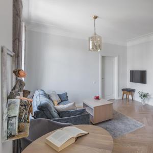a living room with a couch and a table at Avenue in Šiauliai