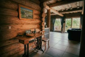 a room with a wooden wall with a wooden table at WOODS LODGE PLITVICE LAKES in Drežnik Grad