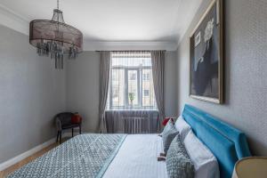 a bedroom with a bed and a window at Avenue in Šiauliai
