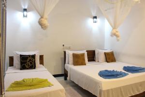 Postel nebo postele na pokoji v ubytování Sigiri Saman Home Stay