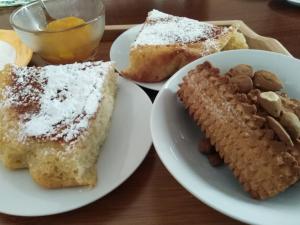 a table with two plates of food with bread and nuts at Casa Mireio in Modica +26 photos
