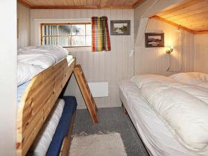 a bedroom with two beds and a window at Holiday Home Krolia in Tjaldal
