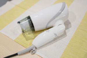 a white blender sitting on top of a table at Uhome Ueno Apartment 4 in Tokyo
