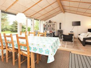 a dining room with a table and chairs at 6 person holiday home in Dronningm lle in Dronningmølle