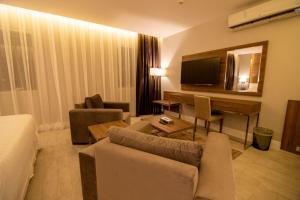 a living room with a couch and a table and a television at قولدن سكوير طريق الرياض Golden Square Riyadh Road in Khamis Mushayt