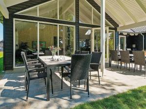 a dining table and chairs on a patio at 18 person holiday home in Hasselberg in Kappeln