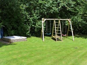 a playground with a ladder and a mattress in a yard at 8 person holiday home in Juelsminde in Sønderby