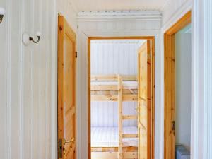a room with a bunk bed and a door at 4 person holiday home in TORUP in Torup
