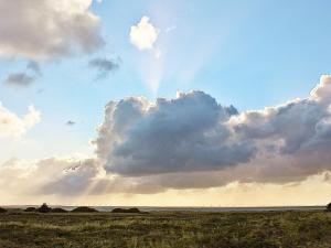 a storm cloud in the sky over a field at 6 person holiday home in Hvide Sande in Hvide Sande