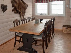 a dining room with a wooden table and chairs at 10 person holiday home in SERAL in Åseral