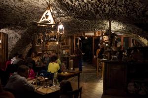 a group of people sitting at tables in a restaurant at Visaisa taverna & foresteria in Acceglio