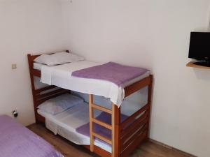 Postel nebo postele na pokoji v ubytování Apartmani Šime - 1