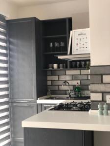 a kitchen with a sink and a stove at Brand new Mellieha sea view apt with parking in Mellieħa