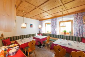 a restaurant with two tables and chairs and two windows at Landhaus Grüner in Sölden