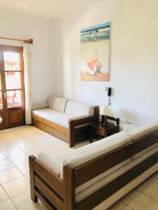 a living room with two beds and a window at Batistas Apartments in Naousa