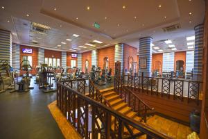 a gym with treadmills and ellipticals in a building at Kampala Serena Hotel in Kampala