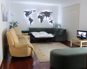 a living room with a couch and a world map on the wall at House near Fontelo in Viseu