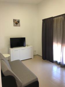 a living room with a couch and a flat screen tv at Camino De Rabe in Rabé de las Calzadas