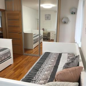 a bedroom with two beds and a mirror at Apartment Tekeľova 95m2 in Prešov