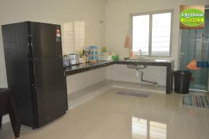 a kitchen with a black refrigerator and a counter at My Homestay N16 (14 pax) @ Golden Hills Night Market in Brinchang