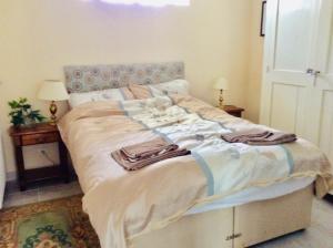 a large bed with towels on it in a bedroom at Gite de Pete in Le Buisson
