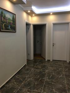 a hallway with a tile floor and a painting on the wall at PASHA APART~BOUTİQUE HOTEL/YALOVA in Yalova