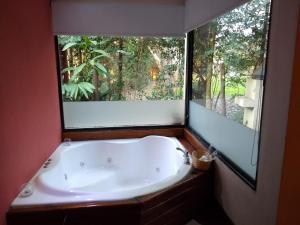 
a white bath tub sitting next to a window at Ruca Lemu in Chascomús
