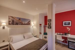 a bedroom with a bed and a red wall at Tritone Top House in Rome