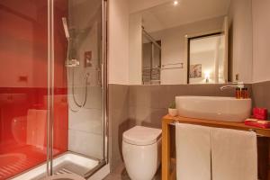 a bathroom with a shower and a toilet and a sink at Tritone Top House in Rome