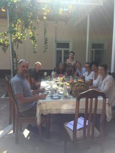 a group of people sitting around a dinner table at Munis in Samarkand