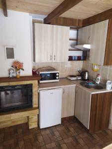 a kitchen with white cabinets and a microwave at Chatki u Natki in Łabowa